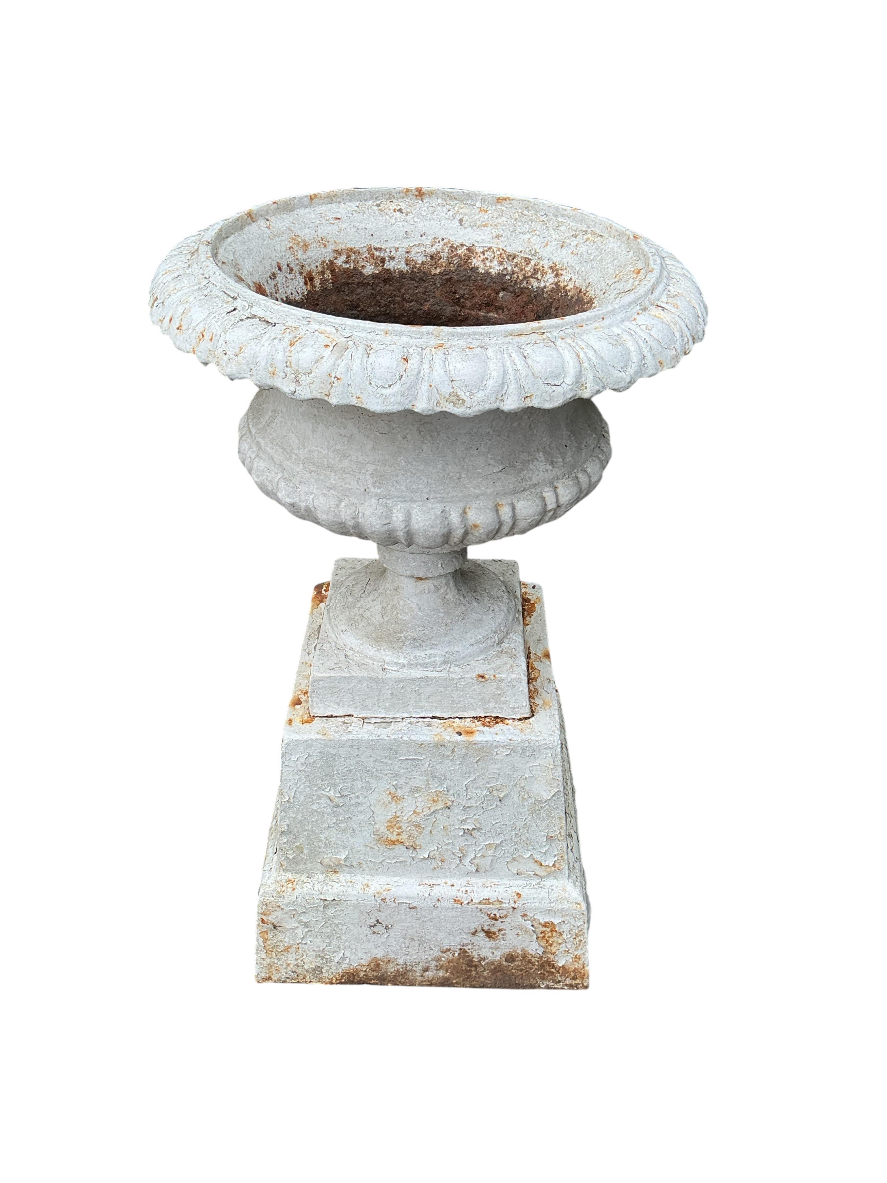 A pair of Victorian painted cast iron campana urns on square bases, diameter 48cm, height 80cm